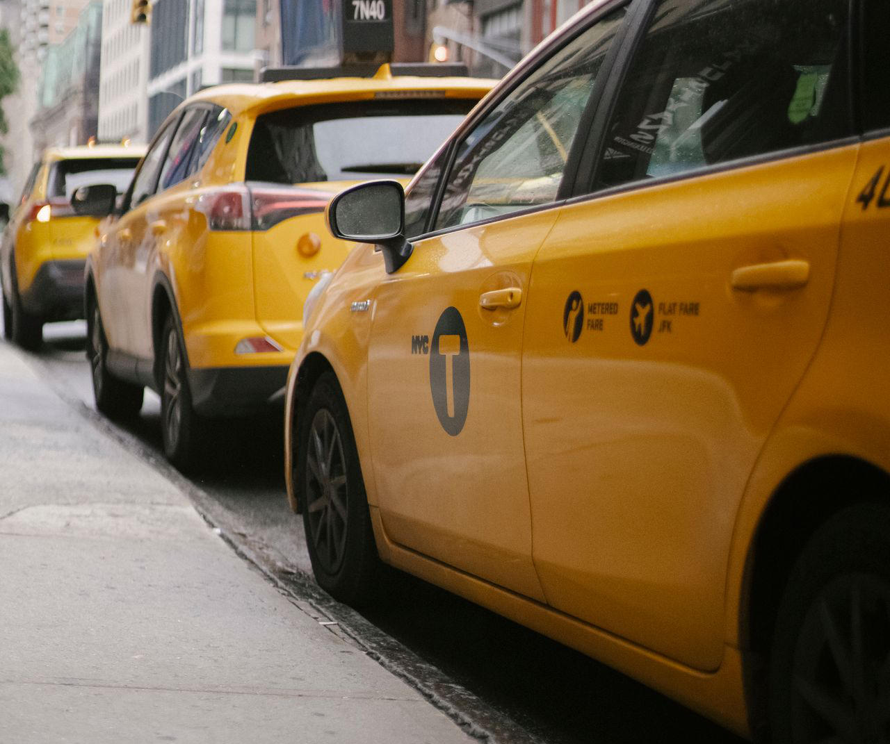 Taxis on a busy city road.